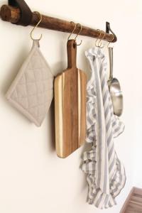 a kitchen rack with cooking utensils and a spatula at Borgo del Canto in Borghetto dʼArroscia