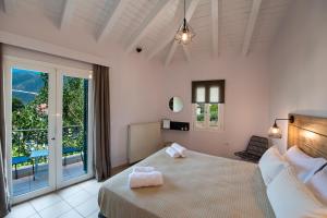 Postel nebo postele na pokoji v ubytování Drakatos Apartments