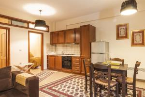 a kitchen with a table and a refrigerator at Monte Bianco Villas in Arachova
