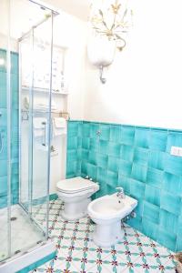 a bathroom with a toilet and a glass shower at Villa Giulia in SantʼAgata sui Due Golfi