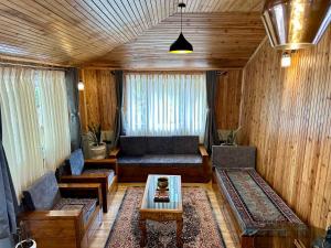a living room with a couch and a table at Pine Forest Retreat in Kurseong