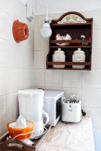 a kitchen counter with a toaster and a microwave at Villa Giulia in SantʼAgata sui Due Golfi