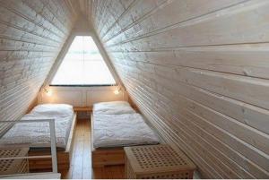 ein kleines Zimmer mit 2 Betten und einem Fenster in der Unterkunft Seeperle 11 mit Ruderboot - ABC211 in Bad Kleinen