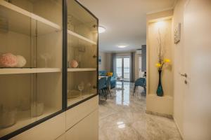 a hallway with glass cabinets and a living room at BLUEMARINE in Umag