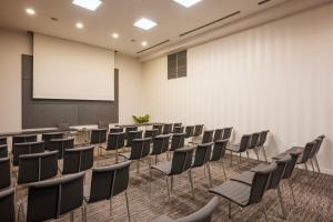 a conference room with chairs and a projection screen at Eurostars Palazzo Zichy in Budapest