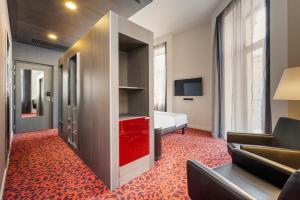 a hotel room with a bed and a red carpet at Eurostars Palazzo Zichy in Budapest