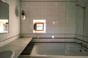 a bathroom with a tub and a sink at Santuario De Bellmunt in Sant Pere de Torelló