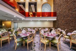 a dining room with tables and chairs and a brick wall at Eurostars Palazzo Zichy in Budapest