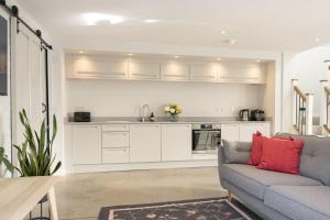 a living room with a couch and a kitchen at Blackwood in Hornsea