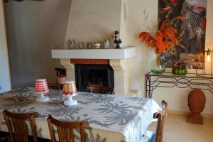 a dining room with a table and a fireplace at La Maison de Saint-Dyé in Saint-Dyé-sur-Loire