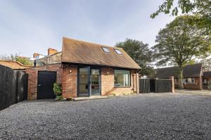 a brick house on a gravel driveway at Blackwood in Hornsea