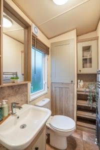 a bathroom with a toilet and a sink at QUEEN V - Luxury Caravan - 2Bed - Seton Sands in Port Seton