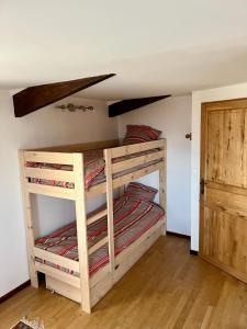 a bedroom with two bunk beds in a room at Les Garennes in Saint-Uze