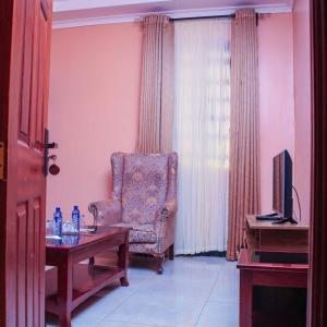 a living room with a chair and a table at Holale Hotel in Moyale