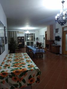 a bedroom with a bed and a dining room at B&B vacanze Mille Colori in Cinisi