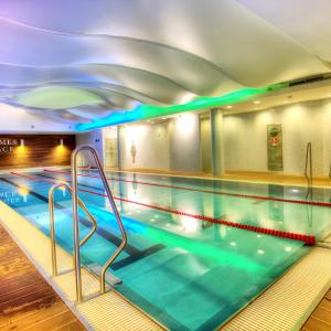 an indoor swimming pool with a pooliteratorhaarhaarhaarythonythonythonythonython at Budapest City Center Apartments in Budapest