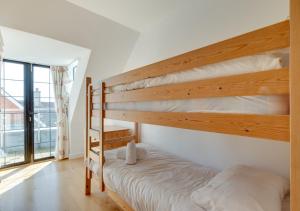 a bedroom with two bunk beds and a window at Flat 9 Broadleys in Swanage