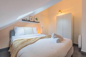 a bedroom with a large white bed in a room at 3 bedroom house with terrace, near Lille in Marcq-en-Baroeul