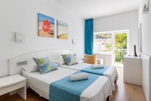 Postel nebo postele na pokoji v ubytování Hostal Neptuno