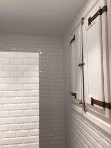 a bathroom with white subway tiles and a window at Cosy & Bright Apartment Near Ramblas in Barcelona