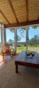 a living room with a wooden table and a chair at Monte da Urze Aljezur in Aljezur