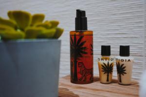 a bottle of oil sitting on a table with a plant at Civico 9 in Brindisi