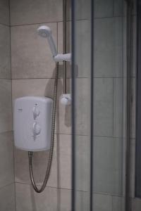 a shower in a bathroom with a shower head at Murrayfield Stadium Basement - 3 Bed 3 Bath in Edinburgh