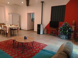 a living room with a christmas tree and a couch at La Grillère in Conliège