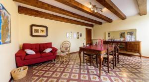 a living room with a red couch and a table at CLARA'S HOUSE 