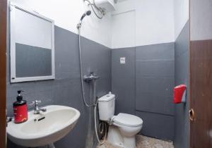a bathroom with a shower and a toilet and a sink at Mega Stay near Mall Kelapa Gading in Jakarta
