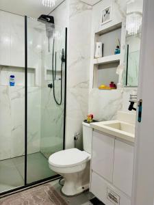 a bathroom with a shower and a toilet and a sink at Cantinho do Aconchego DF in Brasilia