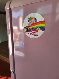 a fridge with a unicorn sticker on it at Alte Schmiede Buckow in Buckow