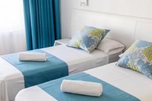 Postel nebo postele na pokoji v ubytování Hostal Neptuno