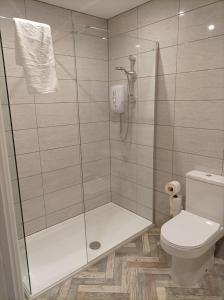 a bathroom with a shower and a toilet at Rose James Apartments in Blackpool +27 photos