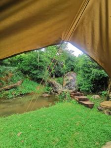a view of a river from inside a tent at Galaha Eco Camping 1 in Kandy