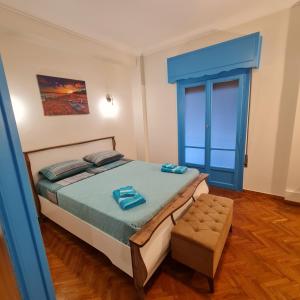 a bedroom with a bed and a blue door at Full apartment near Kato Patissia in Athens