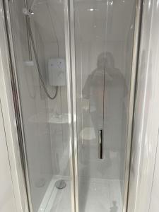 a shower with a glass door in a bathroom at New & delightful 3 bed house in East Kilbride in Glasgow