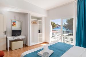 Postel nebo postele na pokoji v ubytování Hostal Neptuno