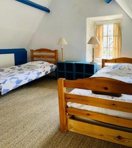 Кровать или кровати в номере Une Chaumière à Port Manech'