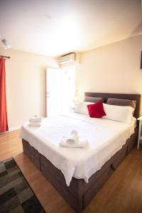 a bedroom with a large bed with towels on it at Apartments Mijajov Dvor in Sumartin +63 photos