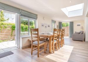 a dining room with a wooden table and chairs at Barnaby Lodge in Aldeburgh