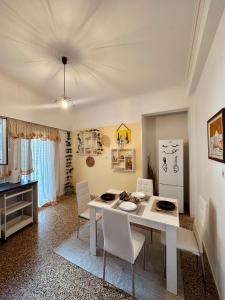 a dining room with a white table and chairs at MaFi Apartment in Ioannina
