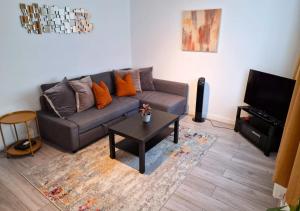 a living room with a couch and a coffee table at FW Haute Apartments at Wembley, Ground Floor 2 Bedroom and 1 Bathroom Flat, King or Twin beds and Double bed with FREE WIFI and FREE PARKING in London