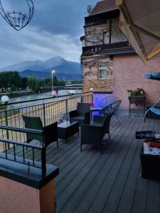 a deck with chairs and tables and a lighthouse at Hotel Heimgartl in Innsbruck +78 photos