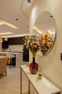 a vase of flowers on a table in a living room at DAR MAYSSA in El Hafsi