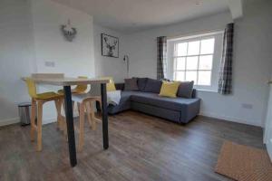 a living room with a couch and a table at Lovely Bakewell apartment in Bakewell
