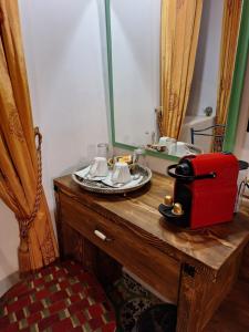 a bathroom with a vanity with a mirror and a red suitcase at Nikos Takis Fashion Boutique Hotel in Rhodes Town