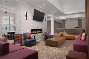 a lobby with couches and a fireplace with a tv at Hilton Garden Inn Abilene in Abilene