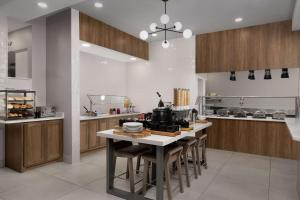 a large kitchen with a table and chairs at Hilton Garden Inn Abilene in Abilene