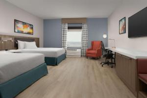 a hotel room with two beds and a desk at Hilton Garden Inn Abilene in Abilene +27 photos